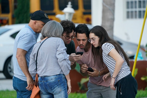 People waited for information after a partial building collapse in Surfside, Fla.