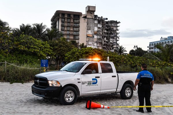 Police officers stood guard near the partially collapsed building.