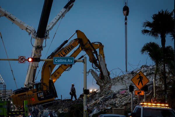 The rescue work continued after dark on Tuesday at the collapse site in Surfside, Fla.